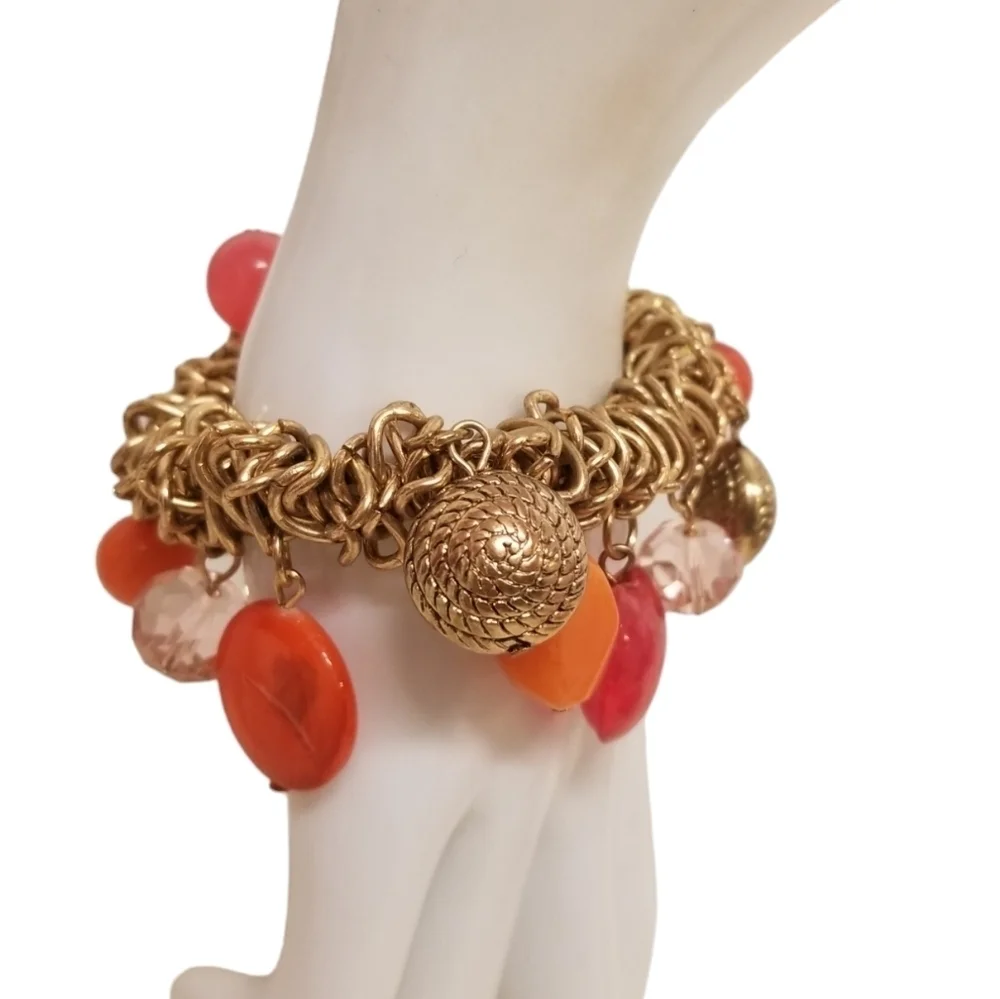 GOLDTONED STRETCH BRACELET WITH BOLD ORANGE & RED GLASS & ACRYLIC CHARMS